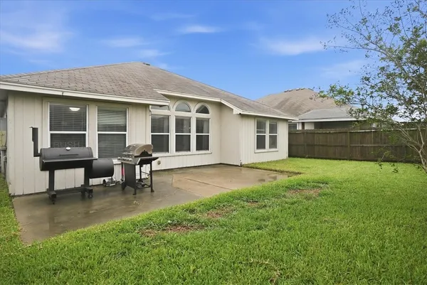 a view of a house with a backyard