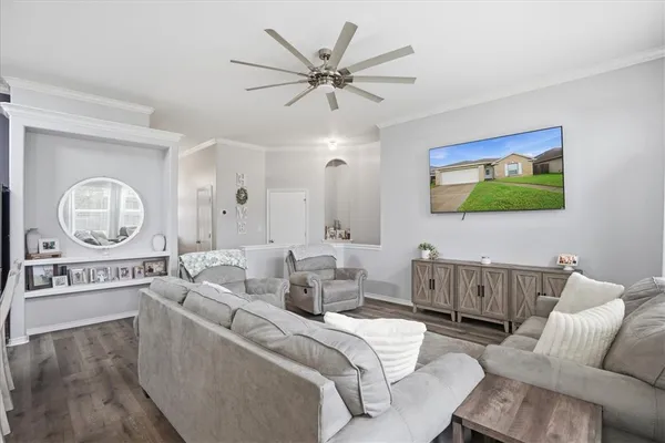 a living room with furniture a chandelier and a large mirror