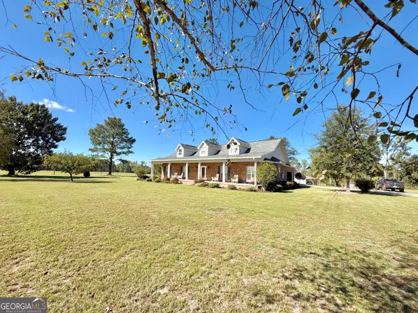 a view of a house with swimming pool and chairs