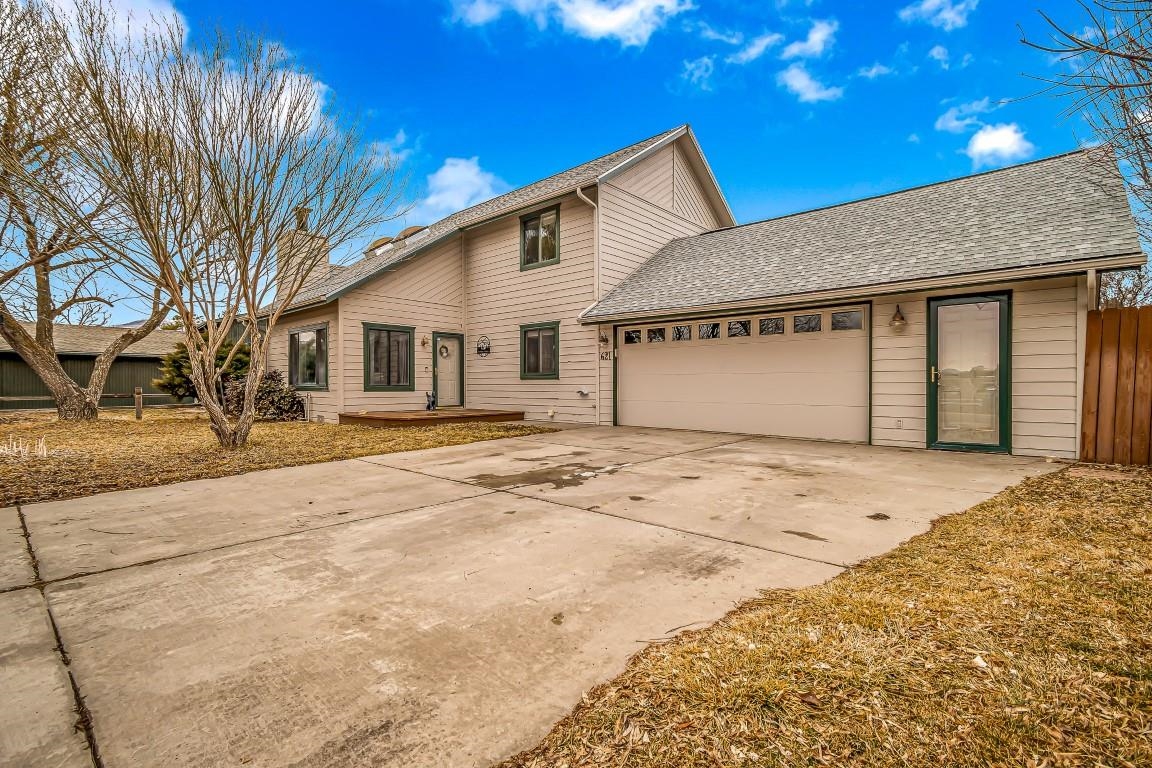 621 Hutton Avenue Rifle, CO 81650 - Photo 1 of 42 a front view of a house with a yard