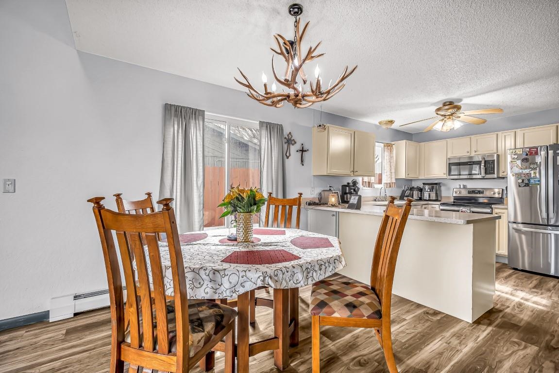 621 Hutton Avenue Rifle, CO 81650 - Photo 5 of 42 a view of a dining room with furniture and wooden floor