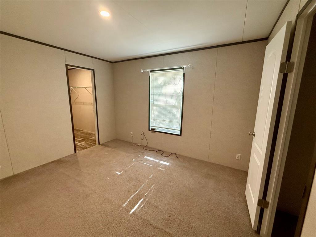 145 Adalida Lane Springtown, TX 76082 - Photo 23 of 29 Carpeted room with a single window, overhead recessed lighting, and a closet featuring wire shelving and wood-finish flooring