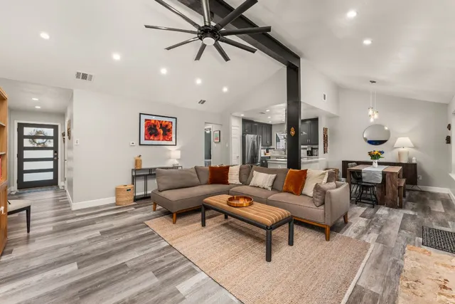 a living room with furniture and wooden floor