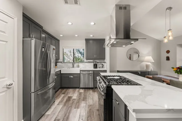 a kitchen with a sink stove and refrigerator