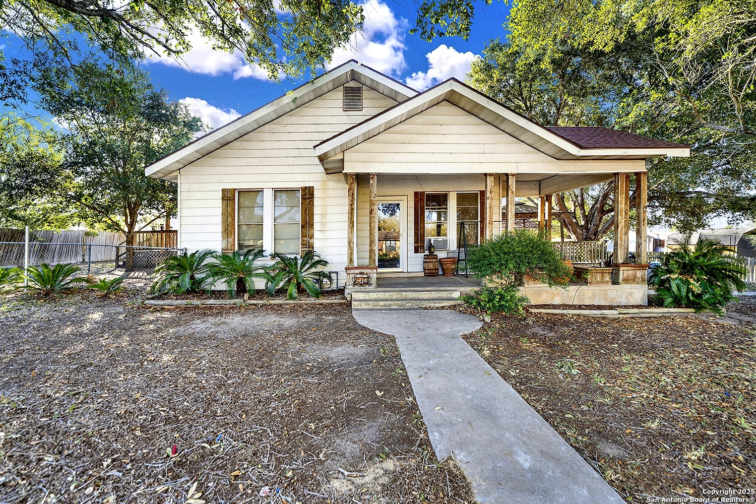 612 East Guadalupe Street Runge, TX 78151 - Photo 1 of 44 a front view of a house with garden