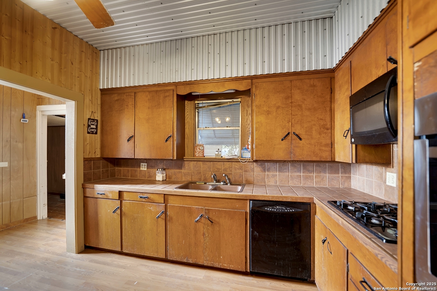 612 East Guadalupe Street Runge, TX 78151 - Photo 19 of 44 a kitchen with granite countertop a sink a stove and cabinets