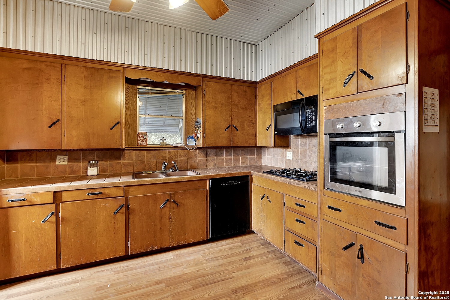 612 East Guadalupe Street Runge, TX 78151 - Photo 20 of 44 a kitchen with stainless steel appliances granite countertop a stove a sink and a microwave