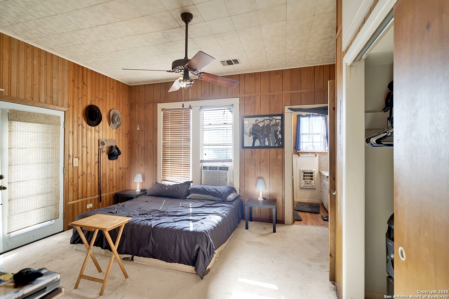 612 East Guadalupe Street Runge, TX 78151 - Photo 23 of 44 a spacious bedroom with a bed and a chandelier