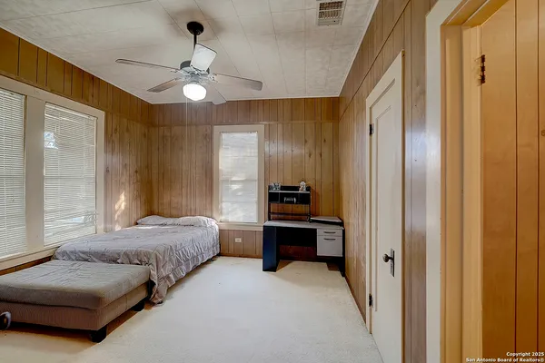 a bedroom with furniture and a window