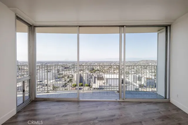 a view of a room with wooden floor and a window