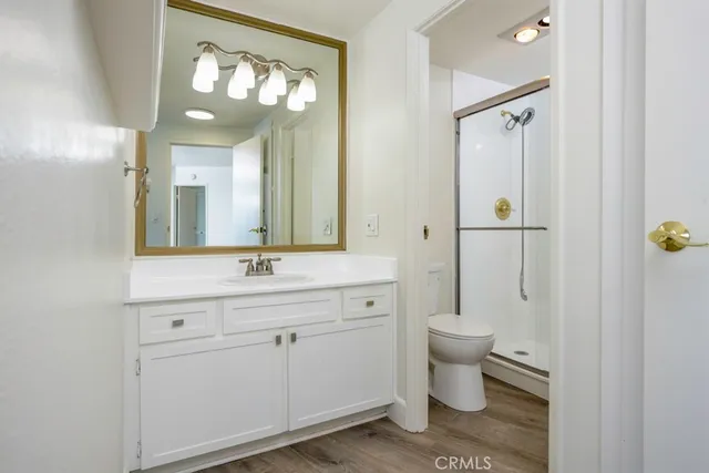 a bathroom with a granite countertop sink toilet and shower