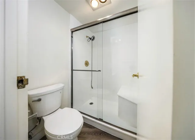 a white toilet sitting next to a bathroom sink