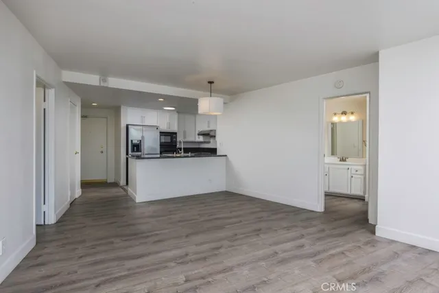 a view of a kitchen with a sink and a refrigerator