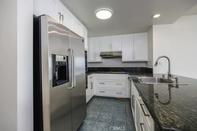 a kitchen with a refrigerator and a sink