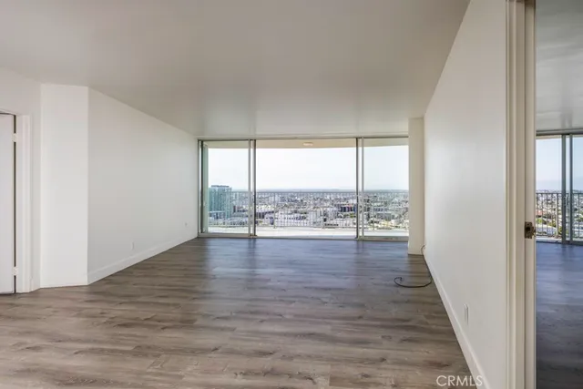 a view of big room with wooden floor and balcony