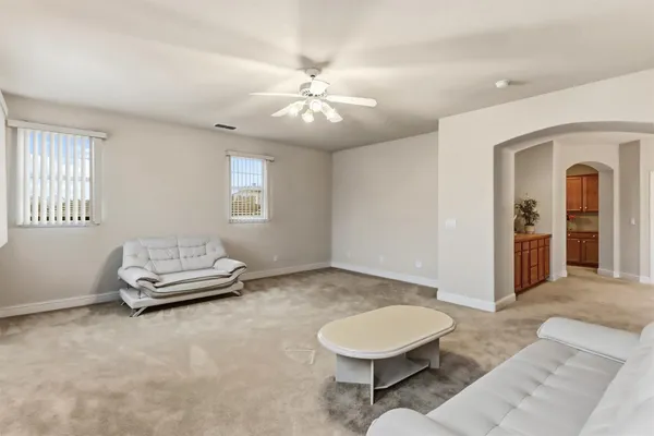 a living room with furniture and a chandelier