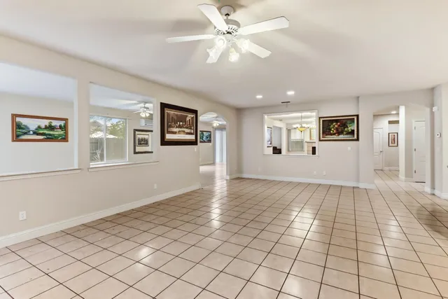 a view of an empty room with window and cabinet