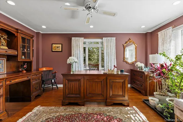 a view of a workspace with furniture and a window