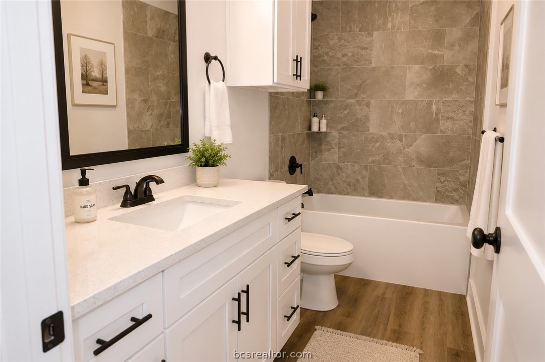 2012 Reagan Court Bryan, TX 77802 - Photo 8 of 19 a bathroom with a sink a toilet and shower