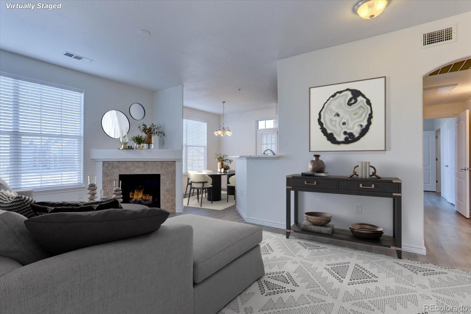 18657 Stroh Road, Unit 4107 Parker, CO 80134 - Photo 1 of 25 a living room with furniture a clock and a fireplace