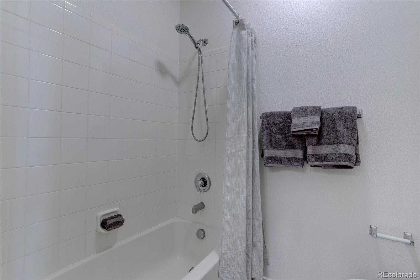 18657 Stroh Road, Unit 4107 Parker, CO 80134 - Photo 12 of 25 a bathroom with a bathtub