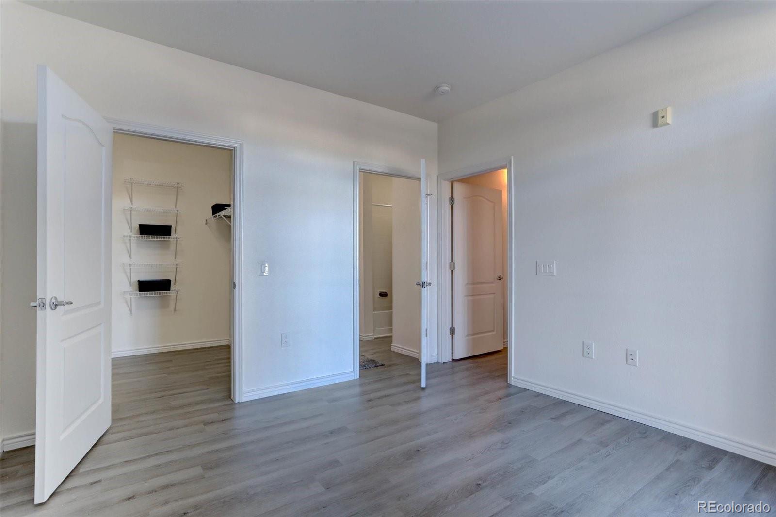 18657 Stroh Road, Unit 4107 Parker, CO 80134 - Photo 13 of 25 a view of an empty room with wooden floor and closet