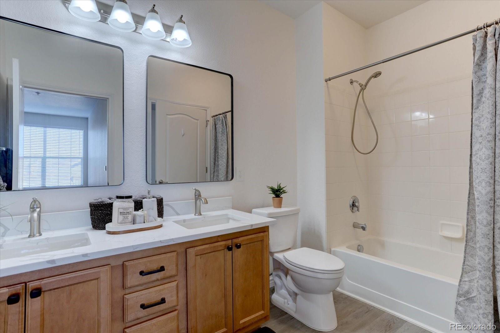18657 Stroh Road, Unit 4107 Parker, CO 80134 - Photo 15 of 25 a bathroom with a toilet a sink and a bathtub