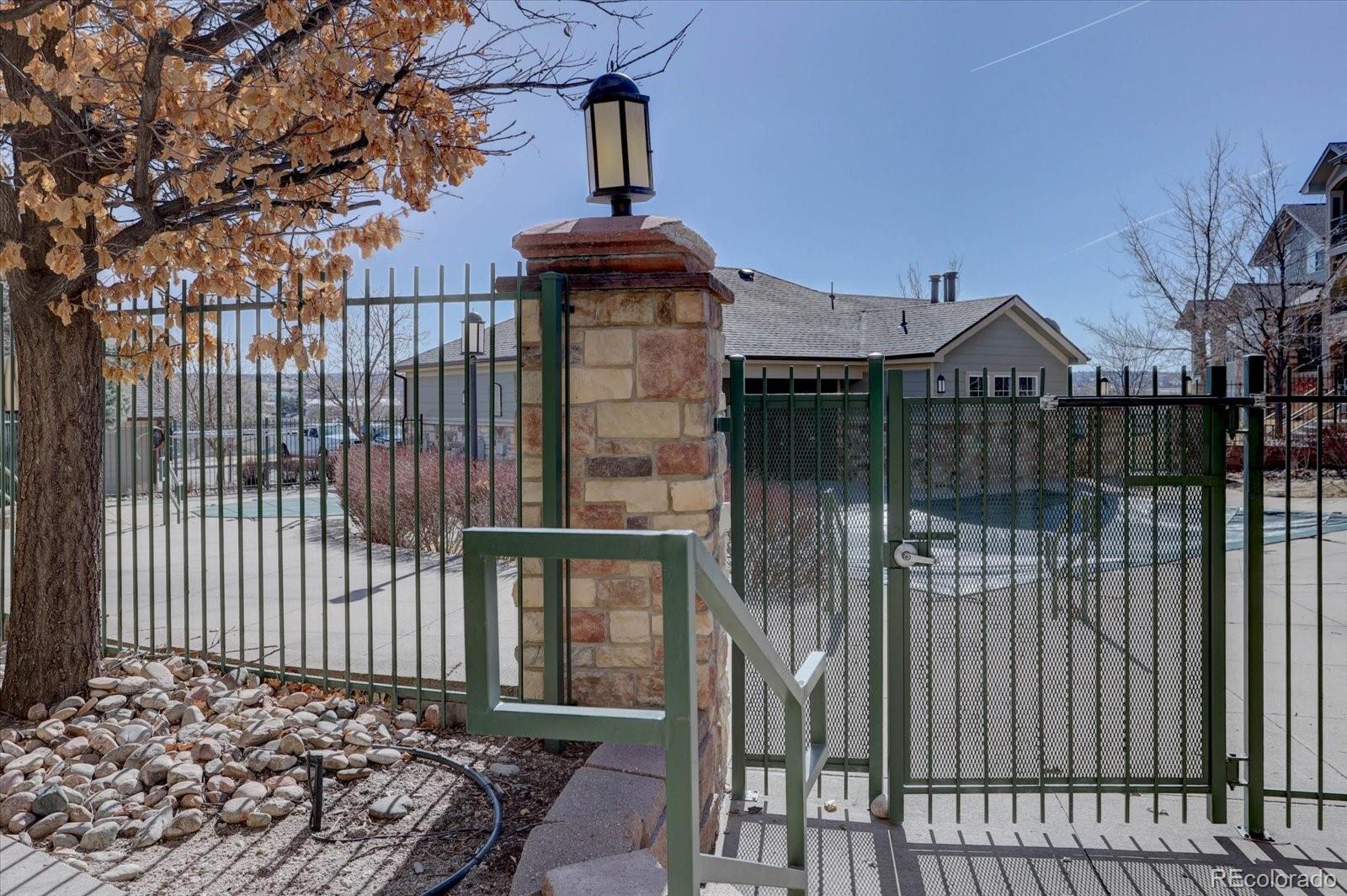 18657 Stroh Road, Unit 4107 Parker, CO 80134 - Photo 25 of 25 a front view of a house with a wooden fence