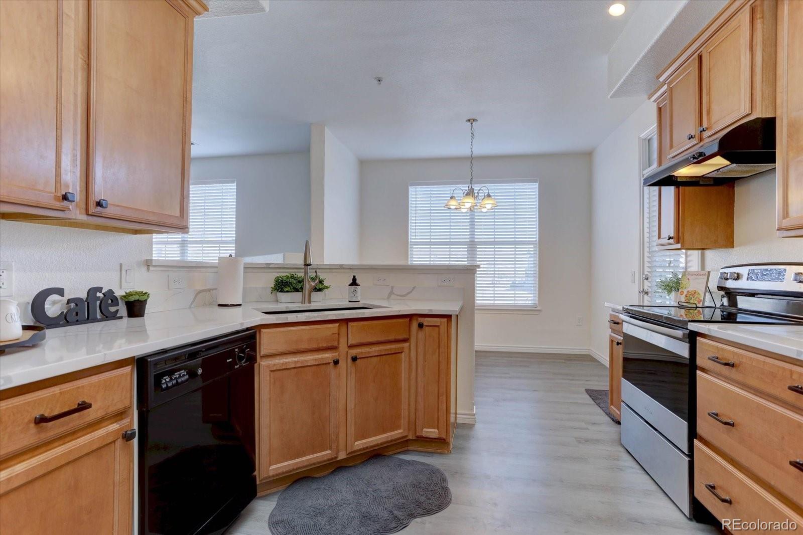 18657 Stroh Road, Unit 4107 Parker, CO 80134 - Photo 3 of 25 a kitchen with stainless steel appliances granite countertop a sink stove and cabinets