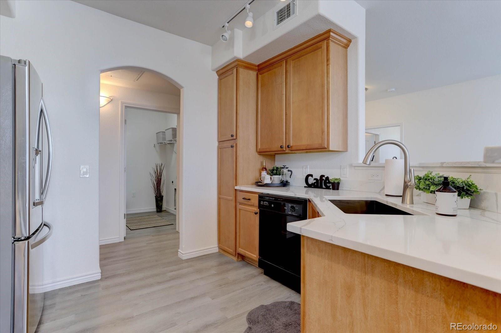 18657 Stroh Road, Unit 4107 Parker, CO 80134 - Photo 4 of 25 a kitchen with a sink appliances and cabinets