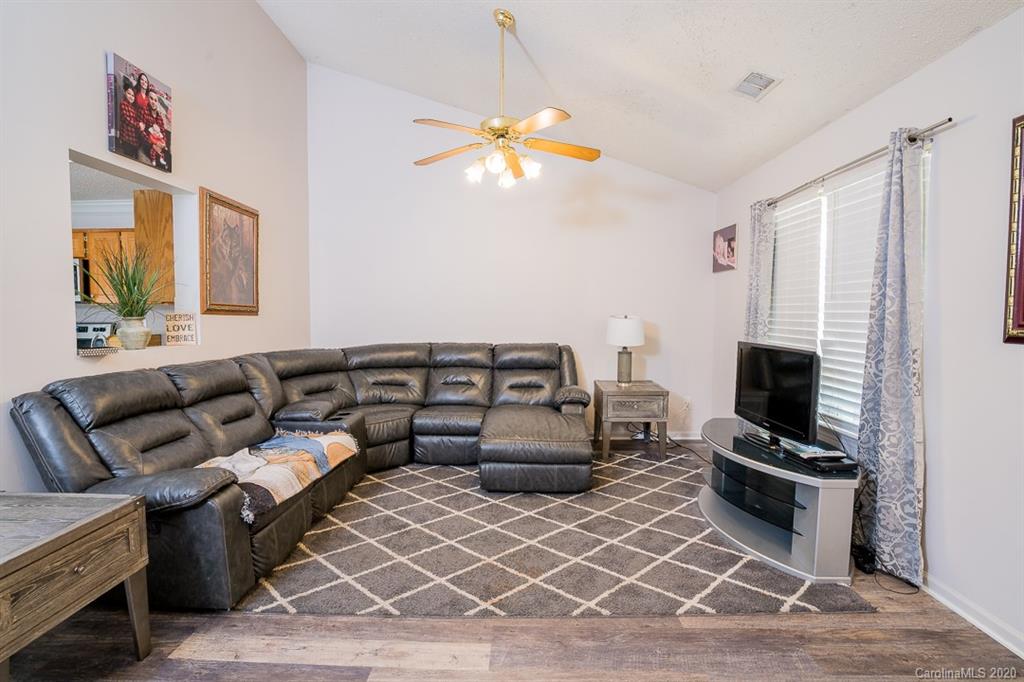 772 Raindrops Road Gastonia, NC 28054 - Photo 14 of 28 a living room with furniture a flat screen tv and a fireplace
