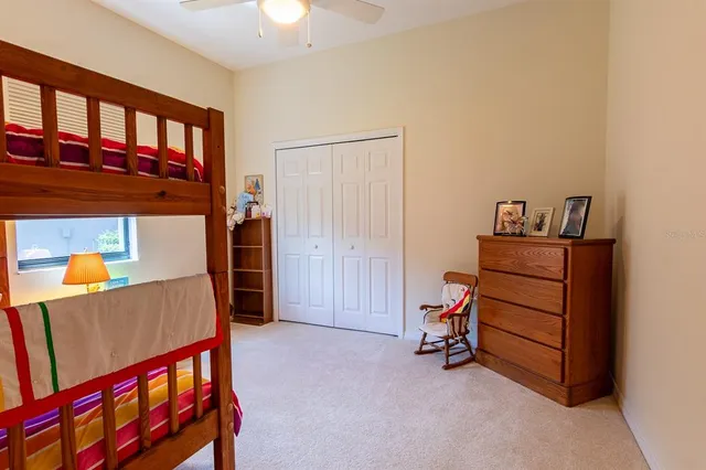a view of a patio with table and chairs potted plants and floor to ceiling window and potted plants