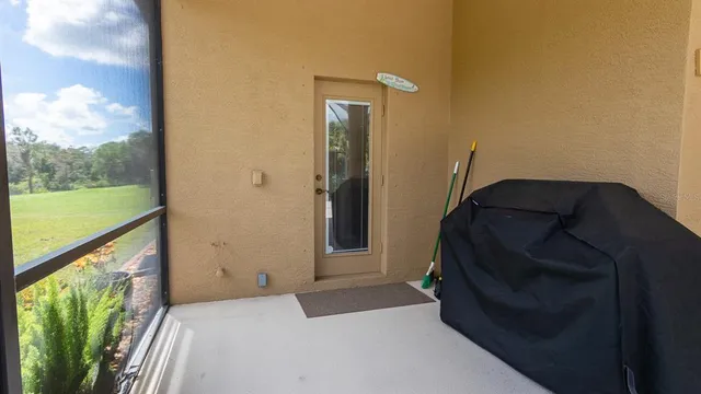 an aerial view of a house with garden space and a car park side of the road