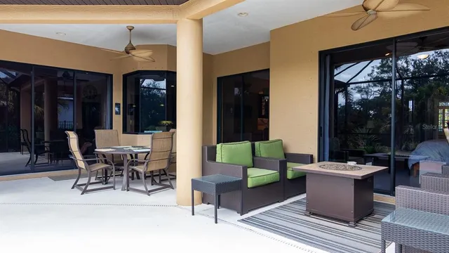 an aerial view of a house with a yard and outdoor seating