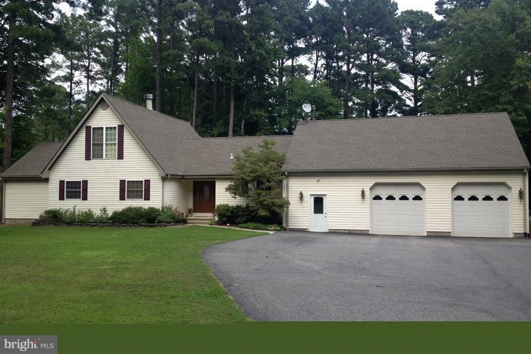 50295 Fresh Pond Neck Road Ridge, MD 20680 - Photo 1 of 10 a front view of a house with a yard and garage