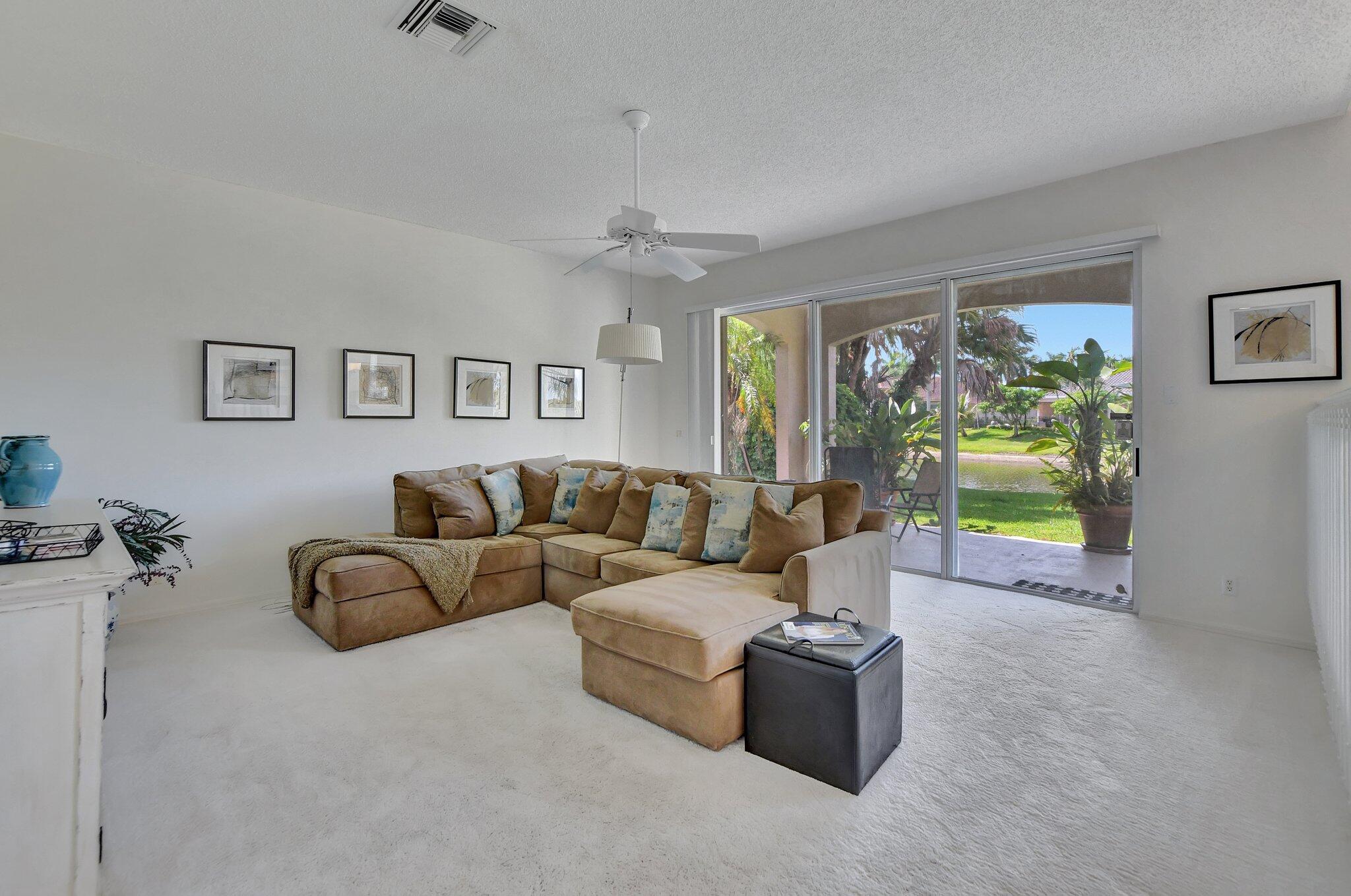 19586 Dinner Key Drive Boca Raton, FL 33498 - Photo 29 of 78 a living room with furniture ceiling fan and a window