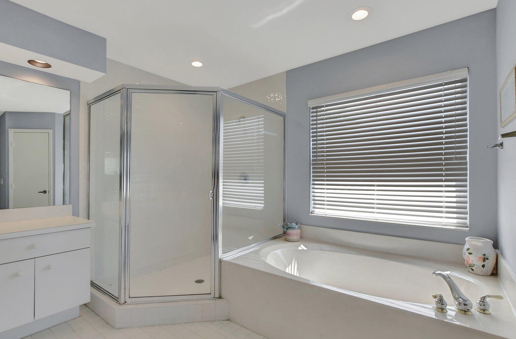 19586 Dinner Key Drive Boca Raton, FL 33498 - Photo 42 of 78 a bathroom with a granite countertop sink and a bathtub