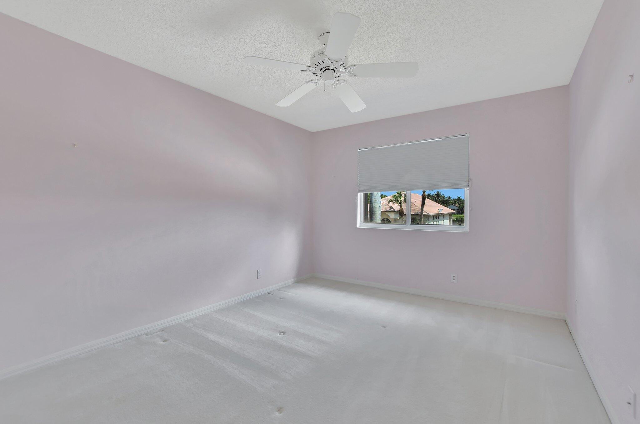 19586 Dinner Key Drive Boca Raton, FL 33498 - Photo 43 of 78 an empty room with a window and a ceiling fan