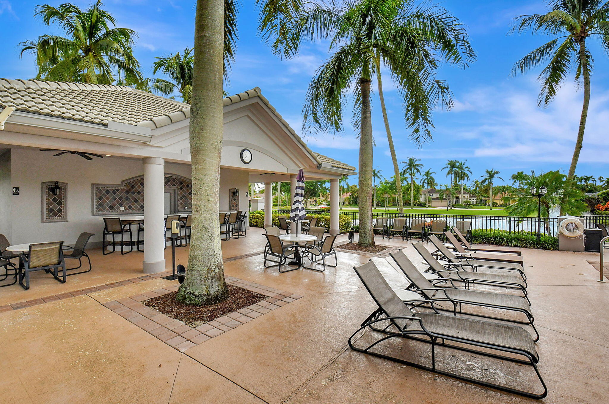 19586 Dinner Key Drive Boca Raton, FL 33498 - Photo 69 of 78 a view of a patio with swimming pool and sitting area