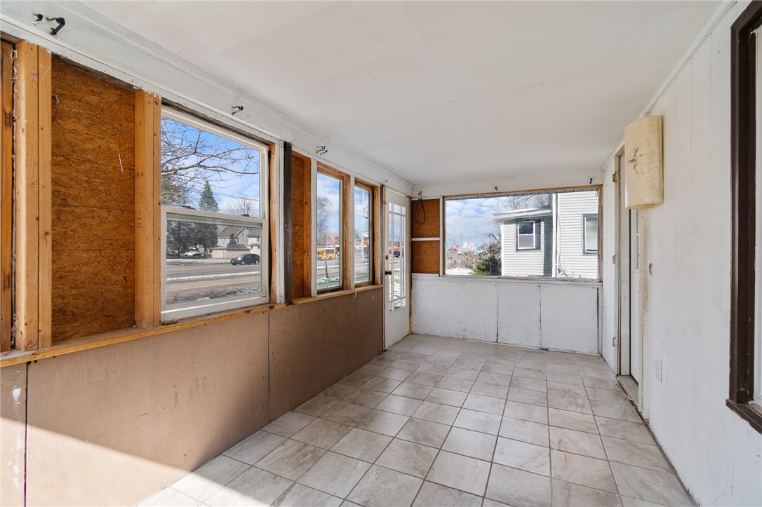4024 Ridgeway Street Williamson, NY 14589 - Photo 7 of 28 The enclosed front porch - a comfortable retreat t