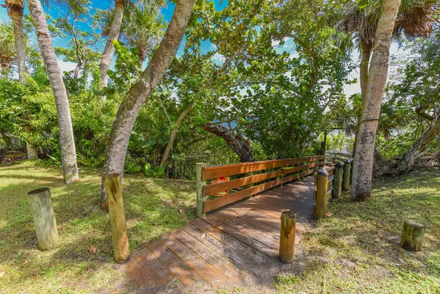 a bathroom with a granite countertop sink and a large window