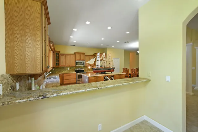 a view of a livingroom with wooden floor and a ceiling fan