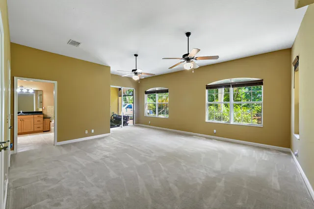 a view of a livingroom with a ceiling fan and window