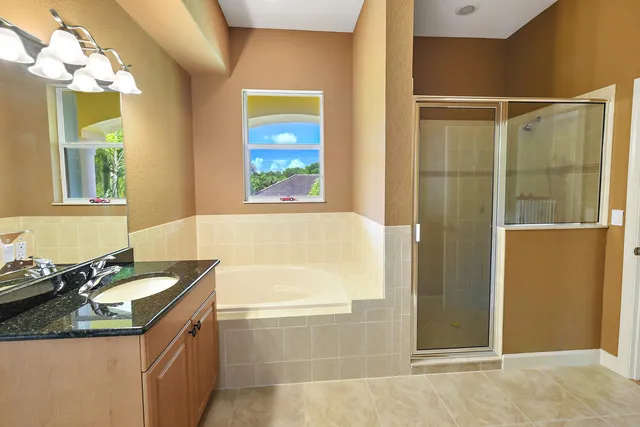 an aerial view of a house with swimming pool and garden