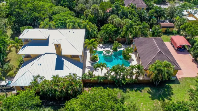 an aerial view of house with yard swimming pool and outdoor seating