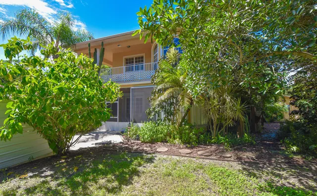 a living room with furniture kitchen view and a chandelier