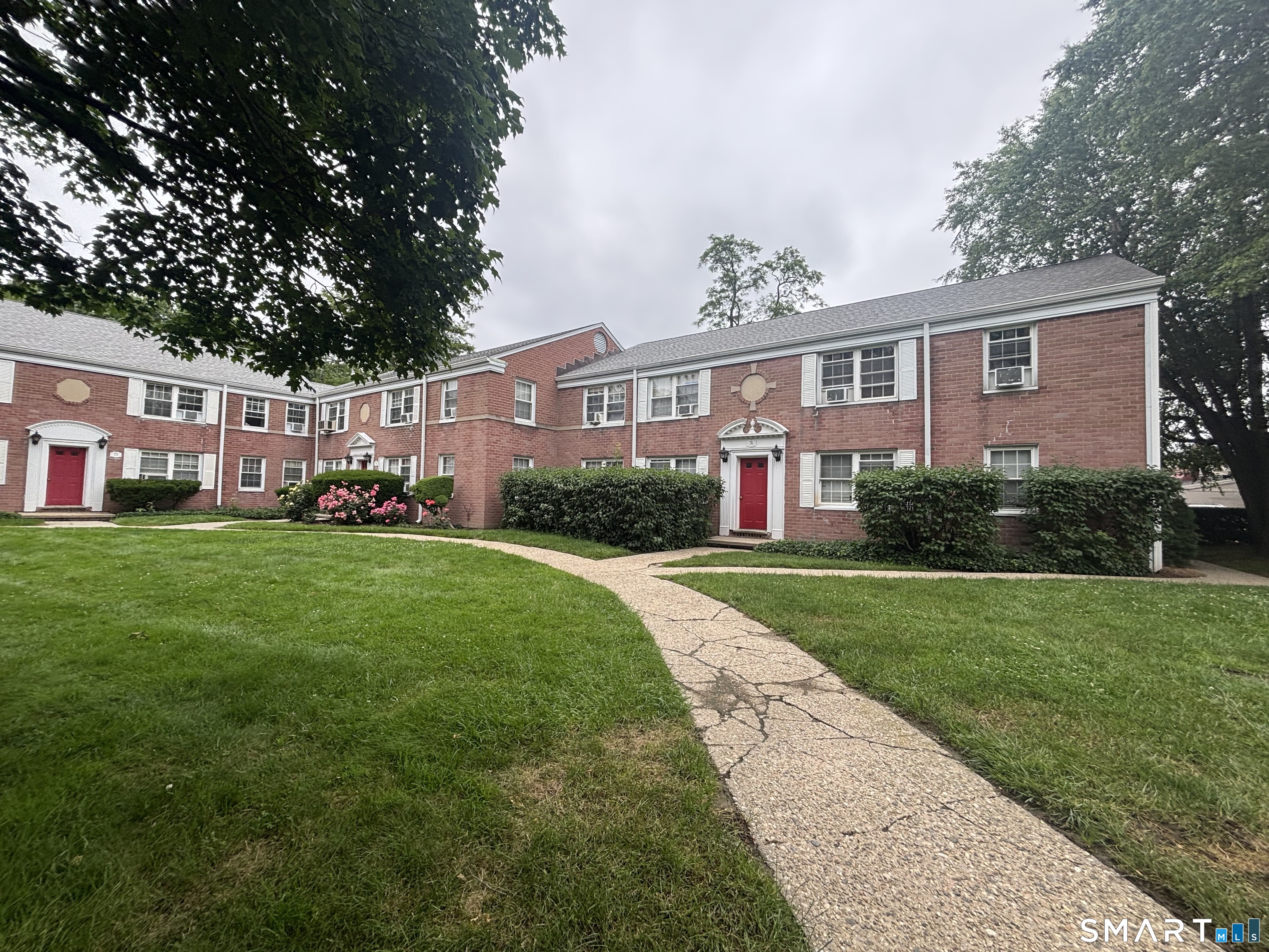 74 Standish Road, Unit 3 Stamford, CT 06902 - Photo 2 of 22 a front view of house with yard and green space
