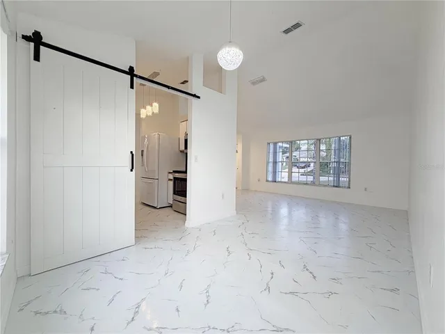 a view of a big room with entryway and wooden floor