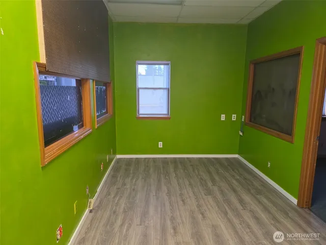 a view of a room that has a bed and a dresser