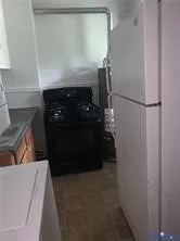 a view of a room with wooden floor and a window